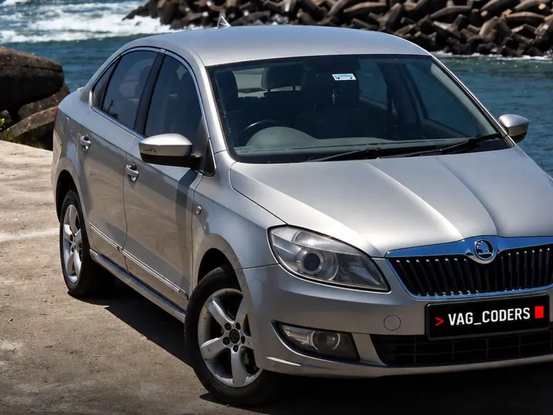 Silver Skoda Rapid 2014 by the sea in Colachel