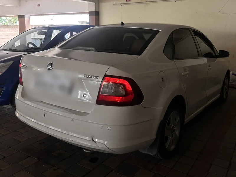 White Skoda Rapid 2017 in Trichy after coding